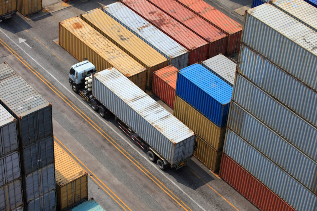 Container yard with cargo trucks for buyer consolidation and freight forwarding services